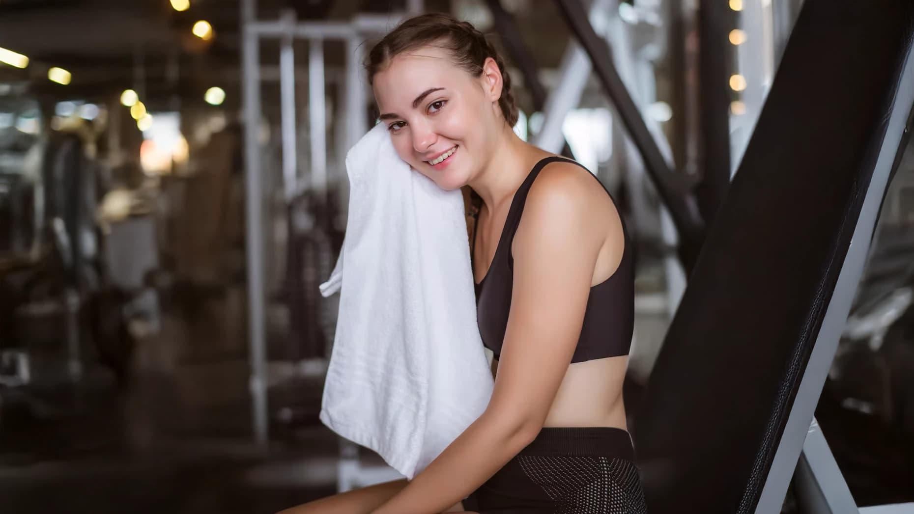 Gym-goer with a towel around their shoulders after training